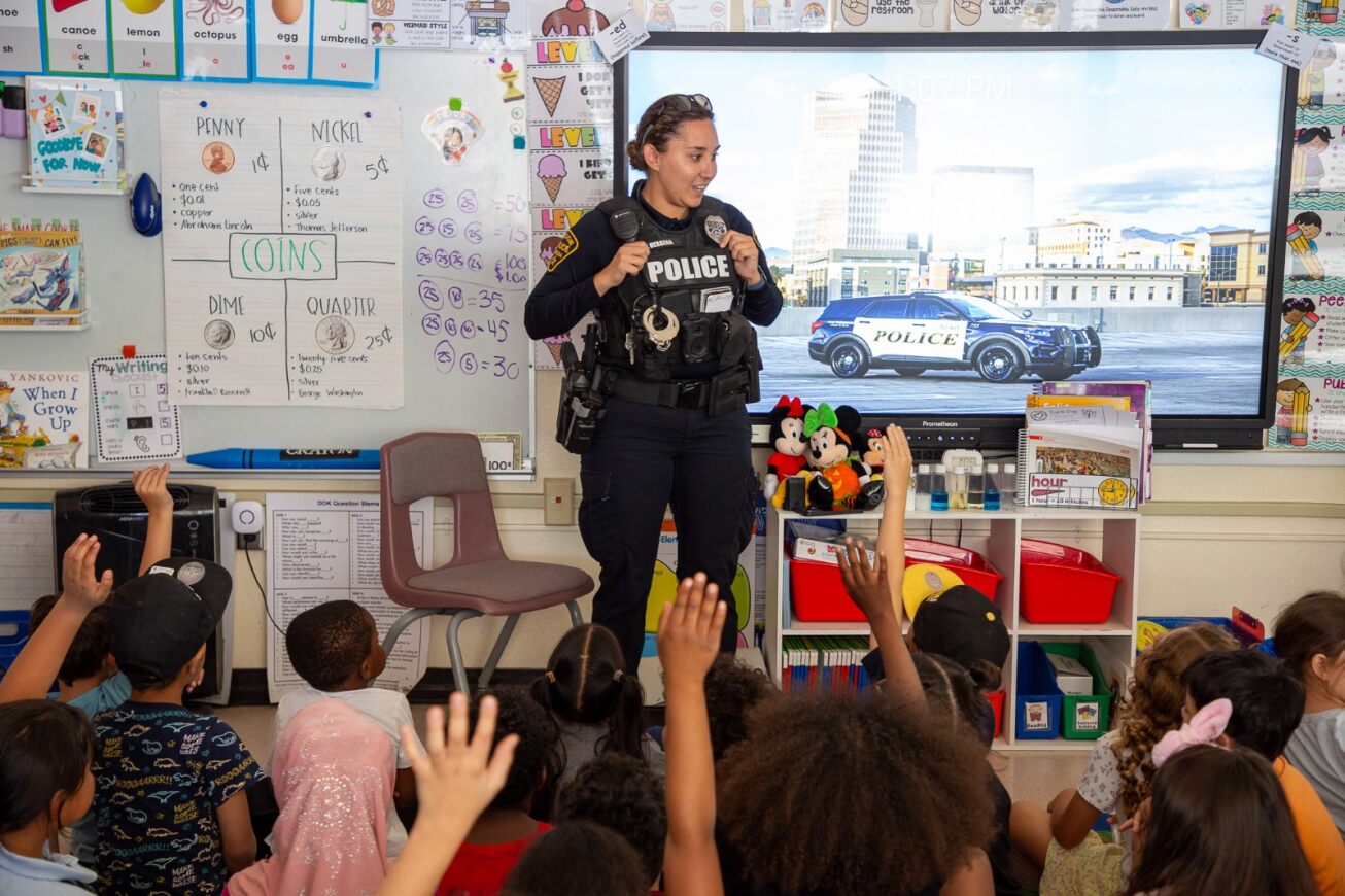 A female police officer presents for students on Career Day
