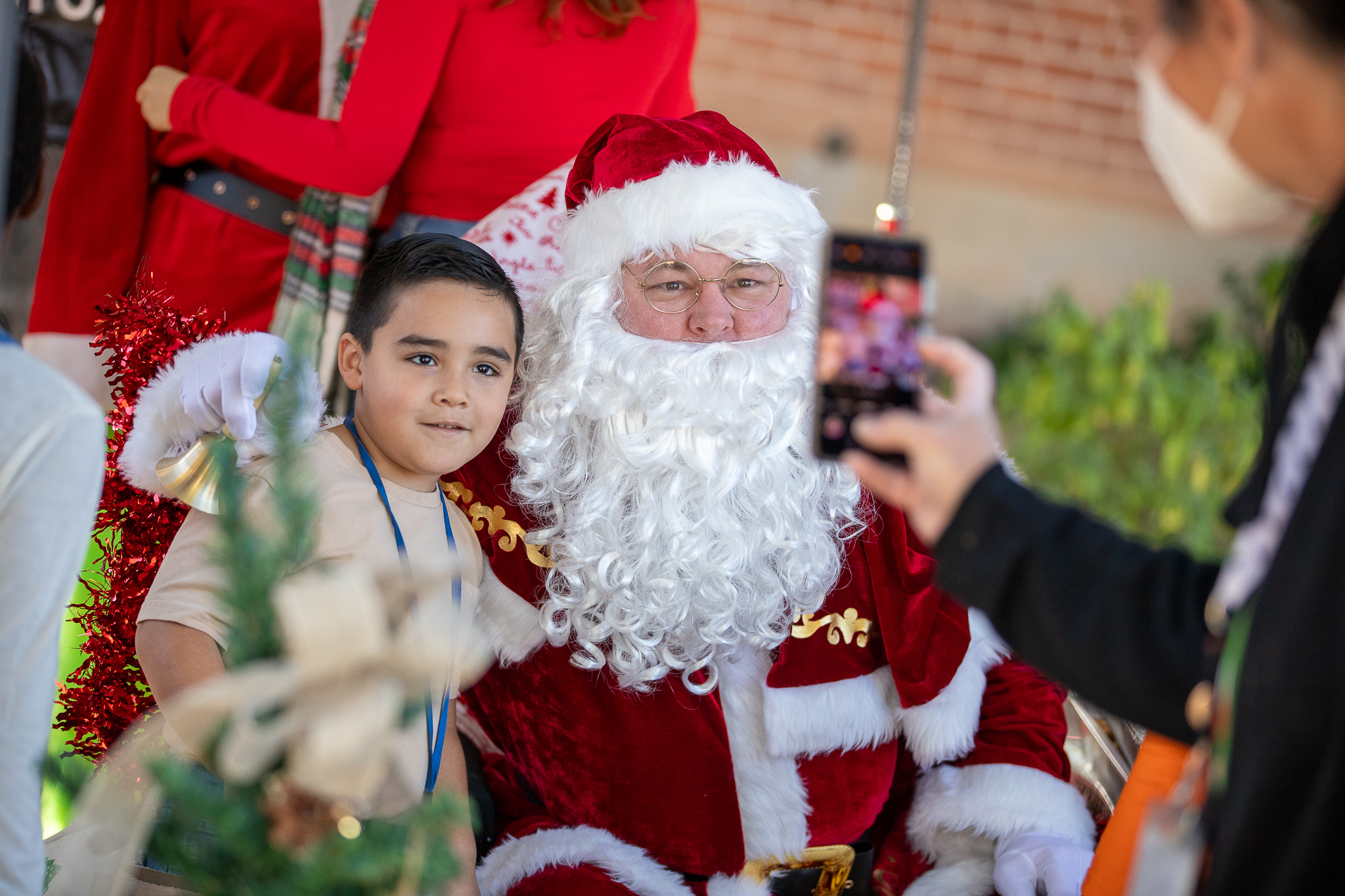 A little boy has a photo taken with Santa