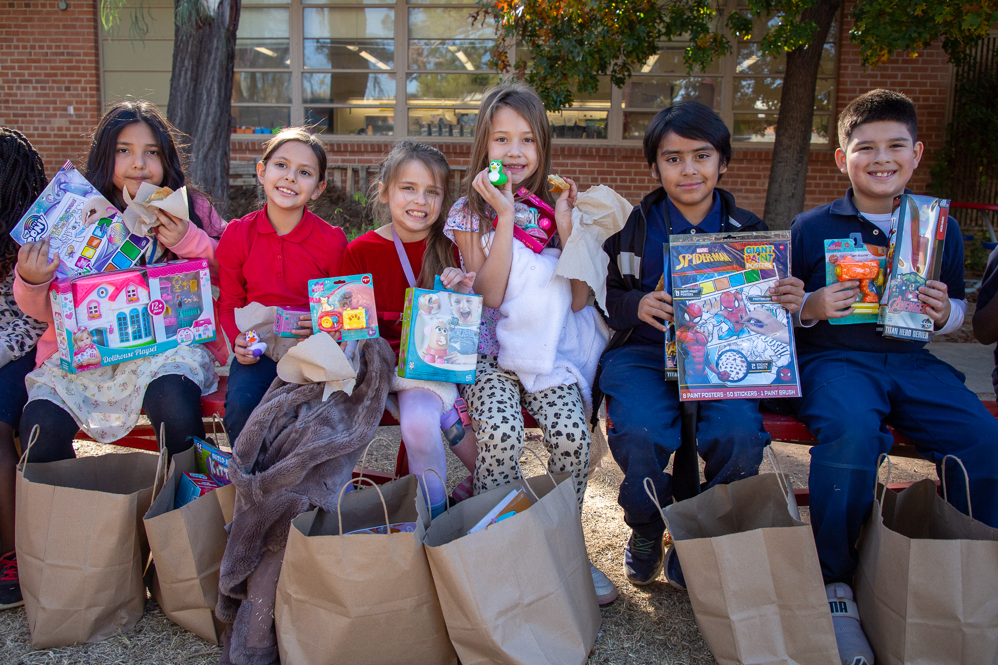 A group of kids smile with their new toys