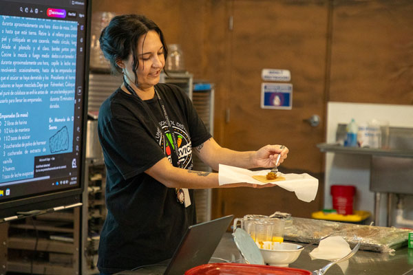 Teacher demonstrates proper technique for making empanadas