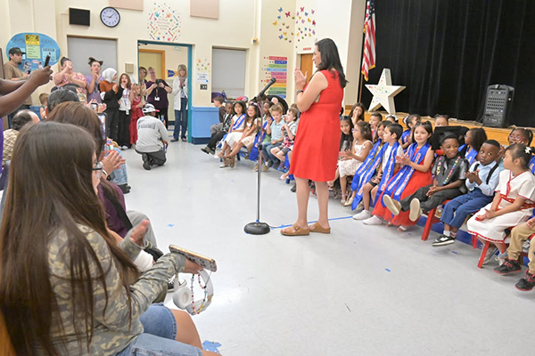 Families clap for their kinder graduates